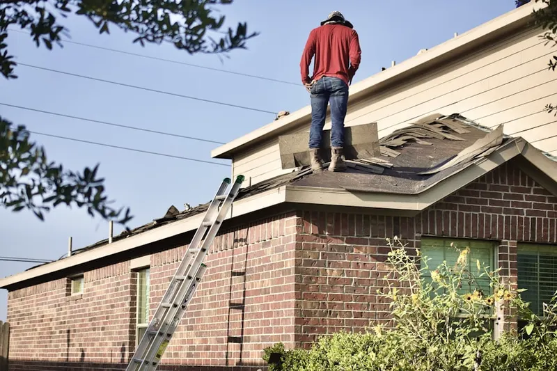 Professional roofer working on a residential roof in Shirley